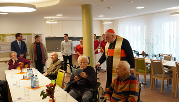 Kardinal Reinhard Marx im Gespräch mit Bewohnern und Bewohnerinnen des neuen Caritas Altenheims Don Bosco. | © Foh/Caritas München-Freising